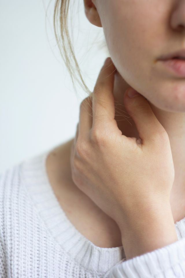 Person touching their throat